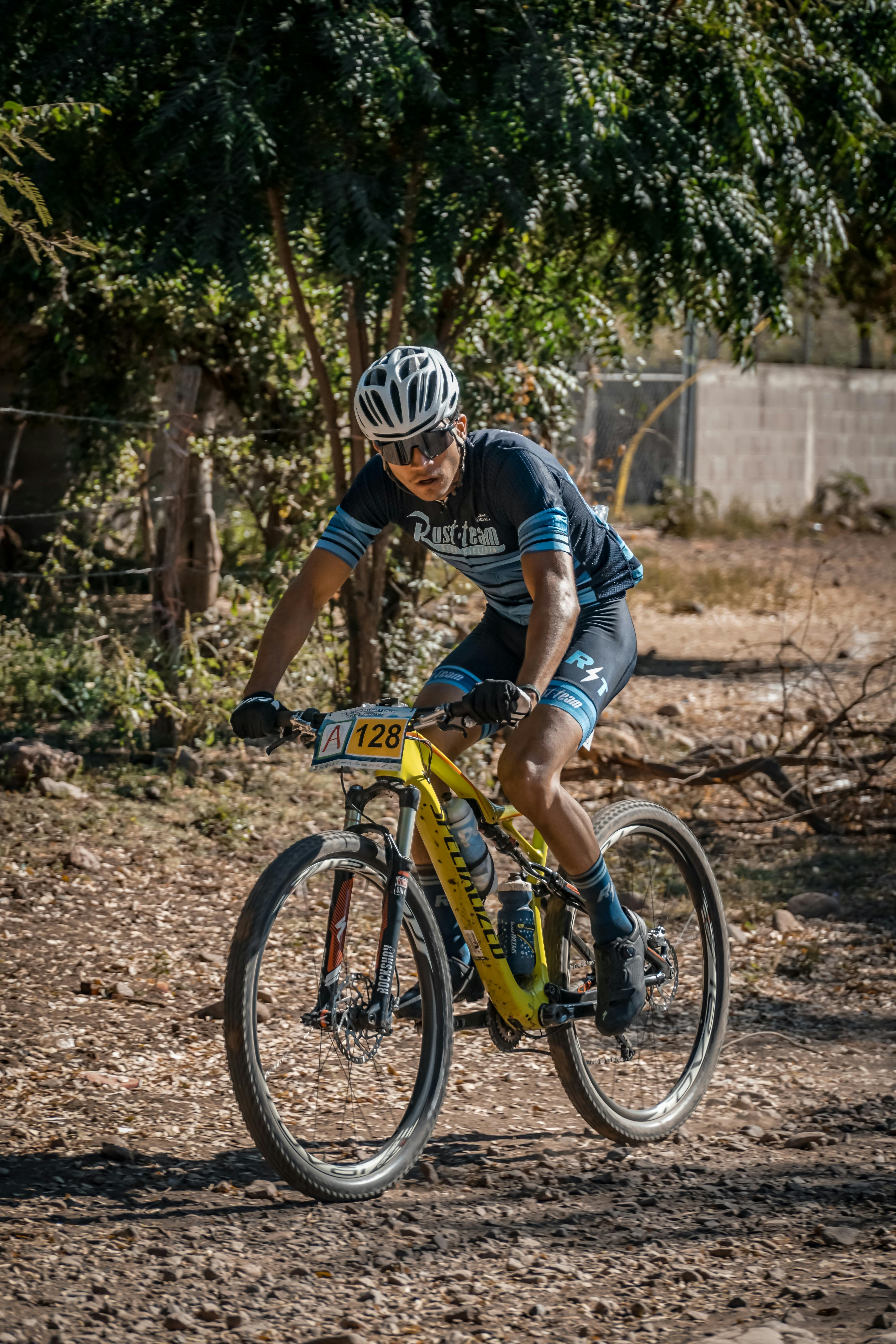 man in blue and black shirt riding on bicycle