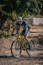 Man in Blue and black Shirt Riding on Bicycle