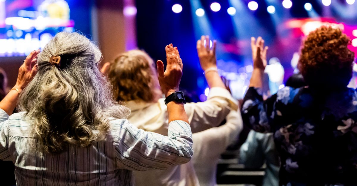 Christ Embassy Loveworld Arena interior worship service crowd hands raised singing