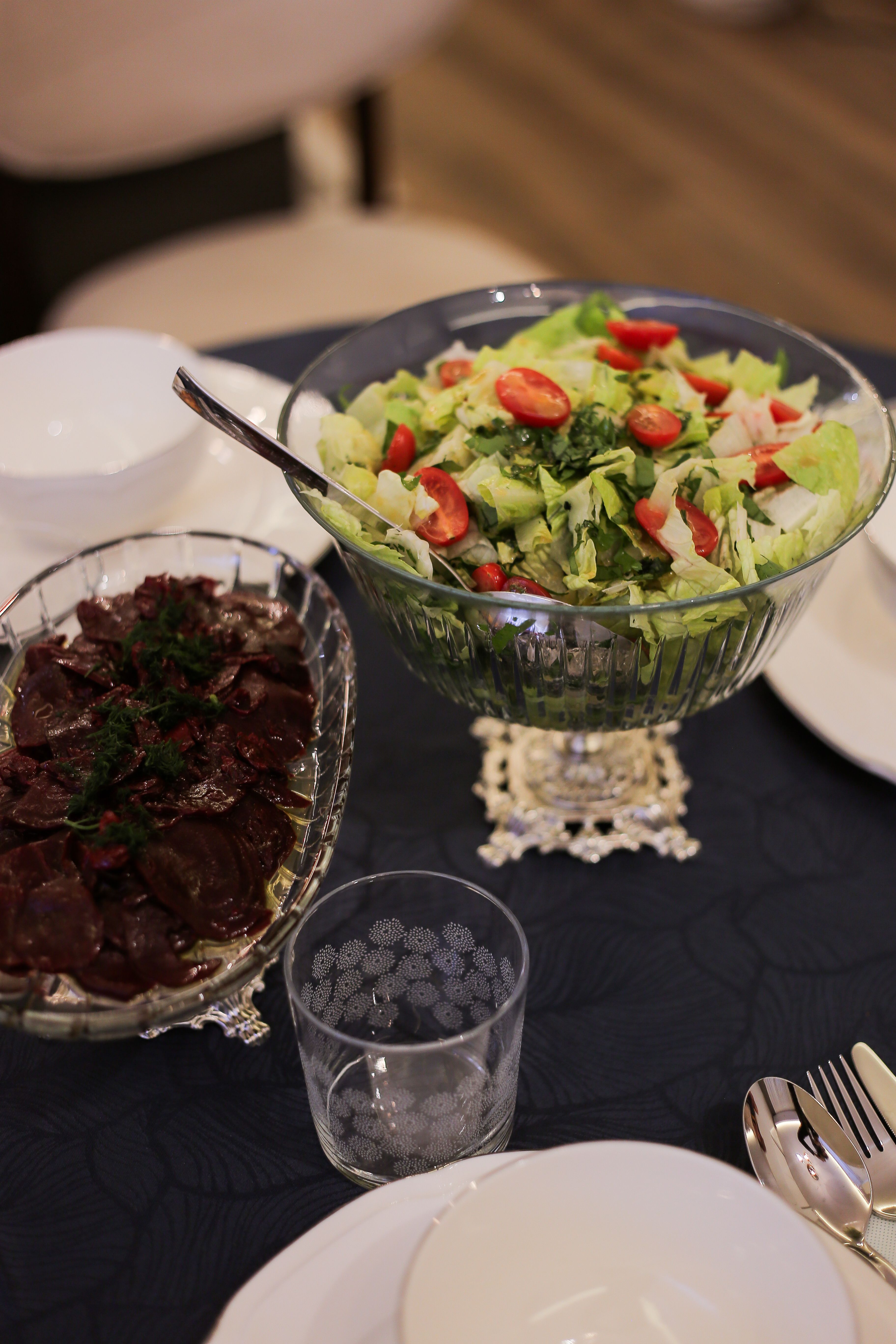 A beautifully set table featuring a fresh salad and beet dish, ideal for gatherings.