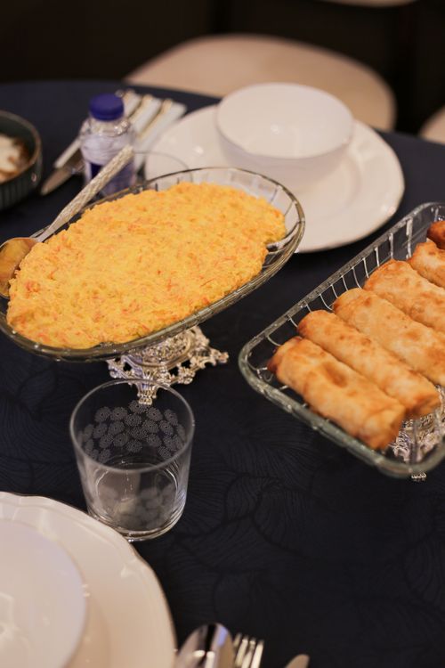 Free A beautifully set table featuring Turkish meze dishes including börek and potato salad, capturing a taste of Türkiye's rich cuisine. Stock Photo