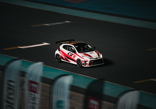 Action shot of a racing car with motion blur on a track in Kuwait City.