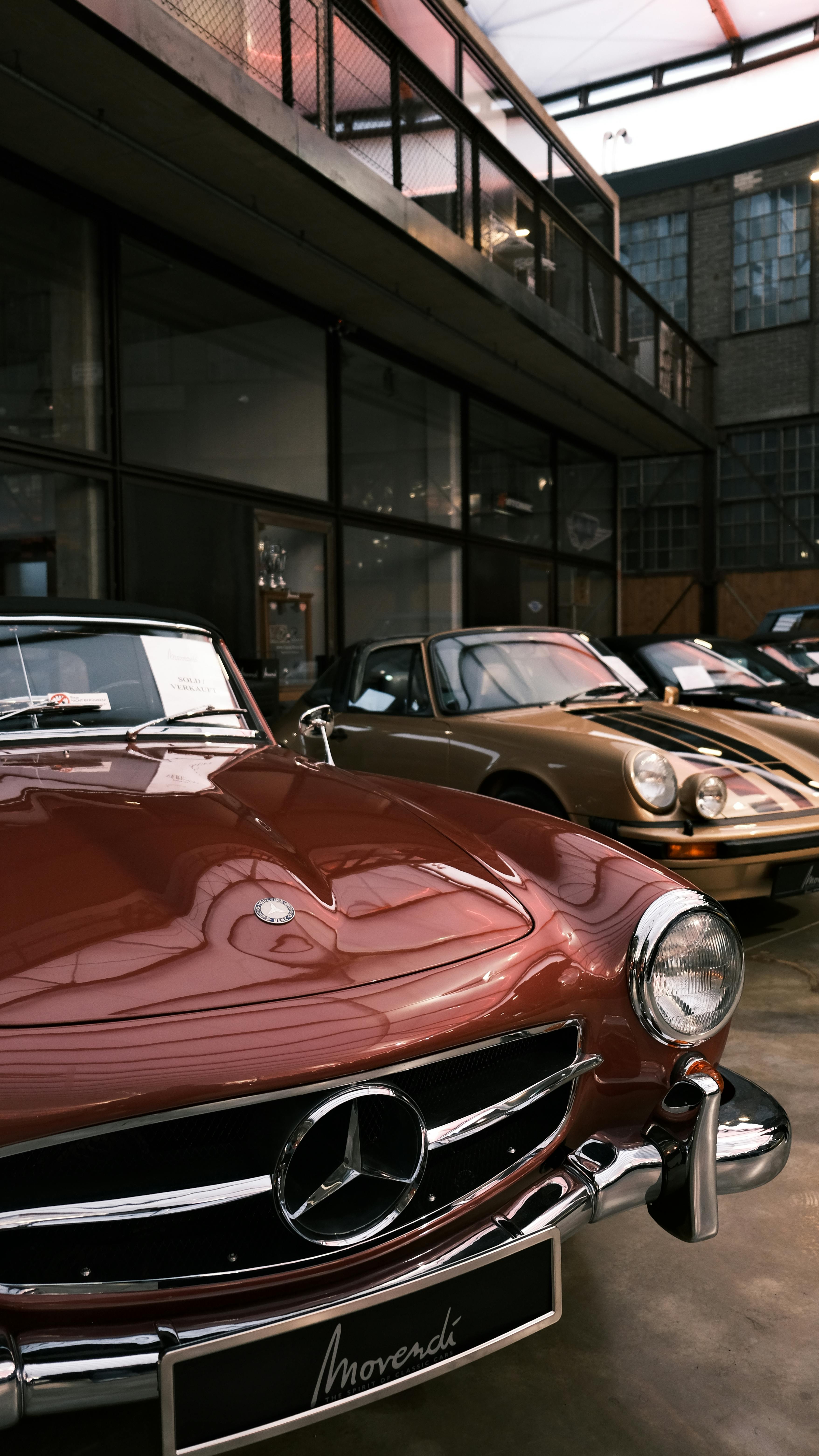Free Vintage Mercedes-Benz and Porsche cars displayed in an indoor showroom in Düsseldorf, Germany. Stock Photo