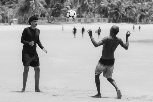 Free Energetic beach soccer match captured in black and white, featuring two players in motion. Stock Photo