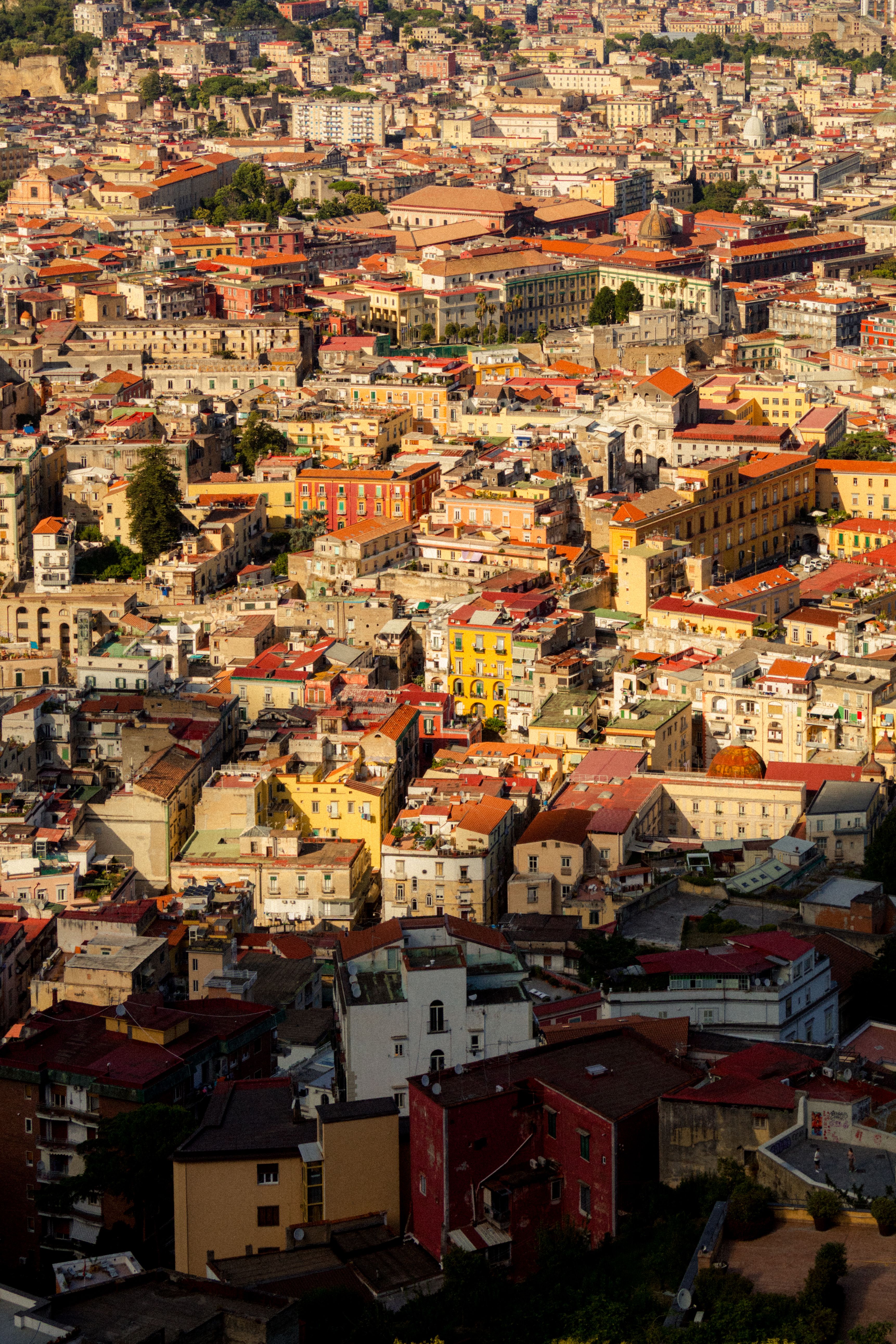 Vibrant aerial cityscape of Naples, showcasing historical architecture and bustling urban life.