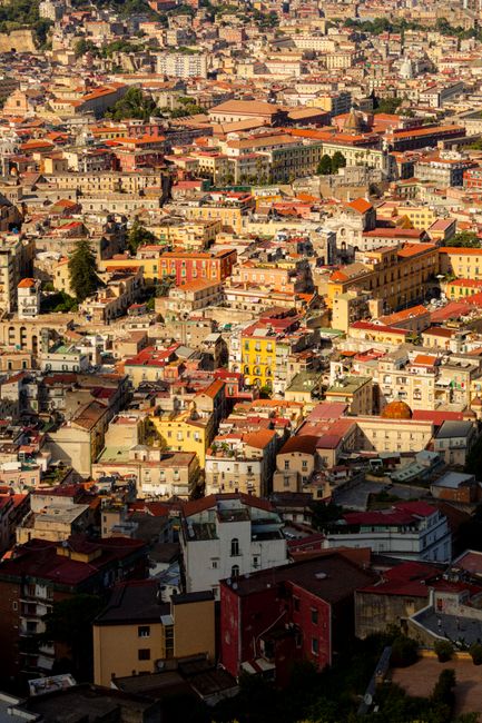 Vibrant aerial cityscape of Naples, showcasing historical architecture and bustling urban life.