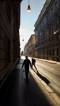 Captivating street scene in Turin, Italy with morning light casting long shadows.