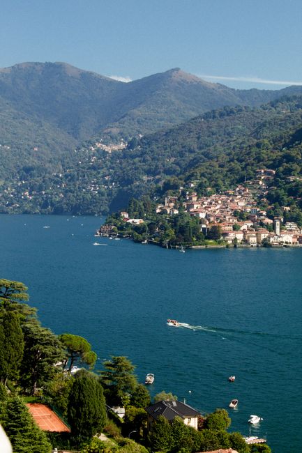 Aerial view of Moltrasio on Lake Como in Lombardy, Italy, showcasing lush hills and serene waters.