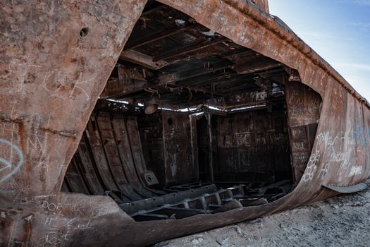 Decayed shipwreck in the Aral Sea desert illustrating ecological disaster and abandonment.