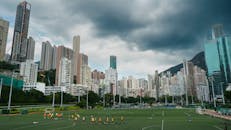 Urban Soccer Field with Skyscrapers and Stormy Sky