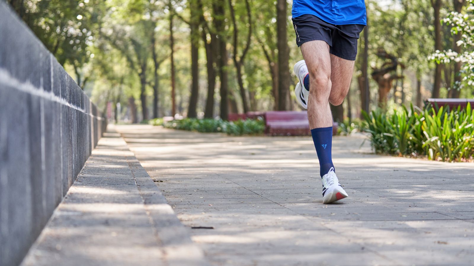 Person adjusting a knee brace before walking outdoors
