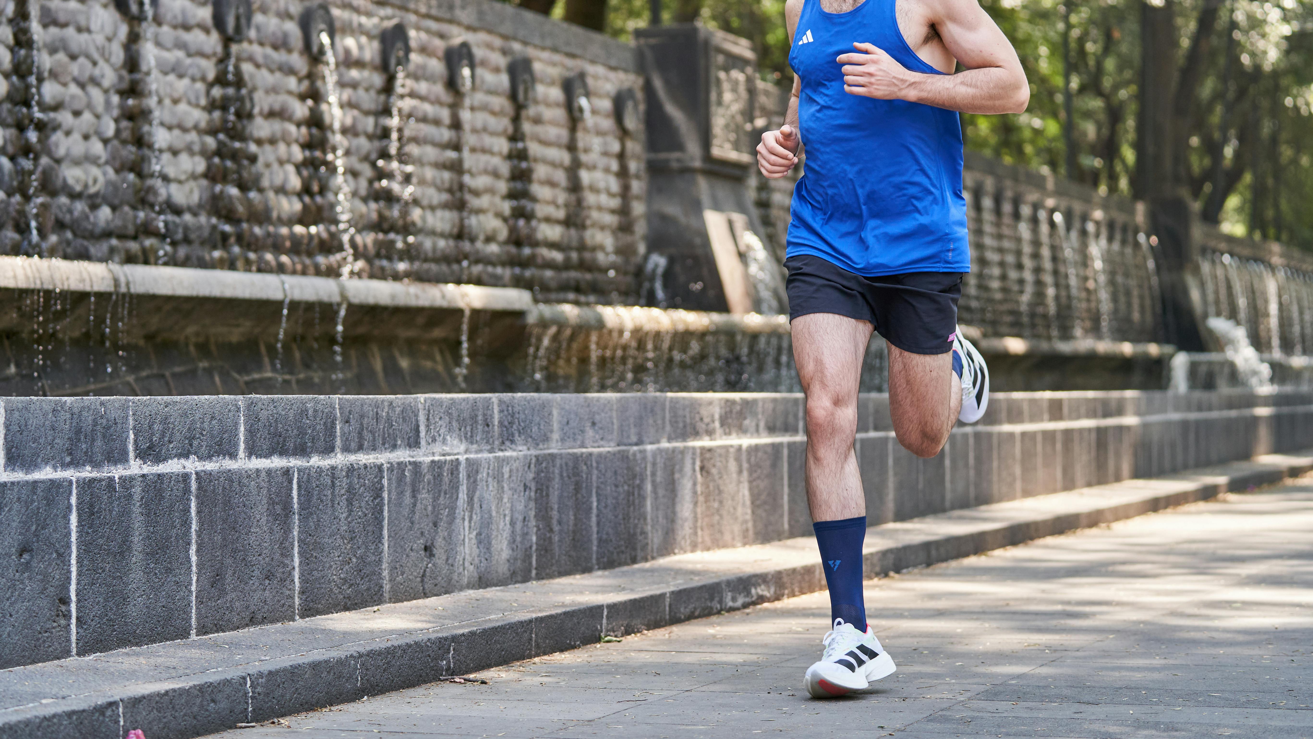 runner on grass path in park, natural light, relaxed footstrike