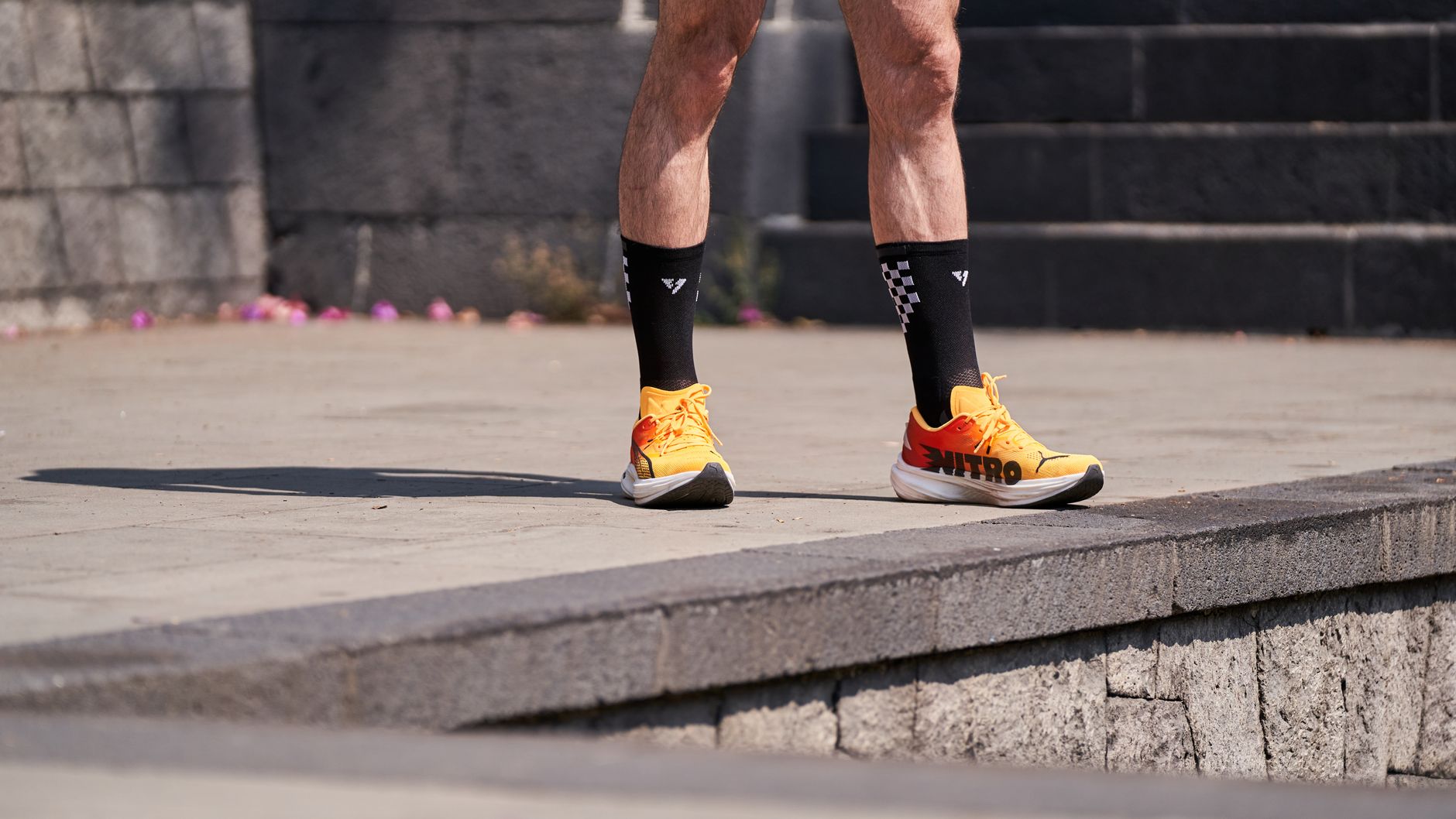 Runner on the road with lower legs visible, matching compression sleeve selection for shin splints. Photo: Pexels.