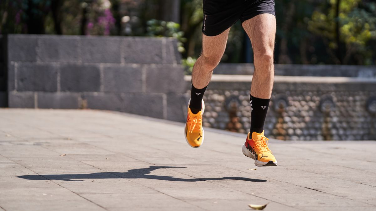 Athletic runner moving outdoors in modern performance sportswear