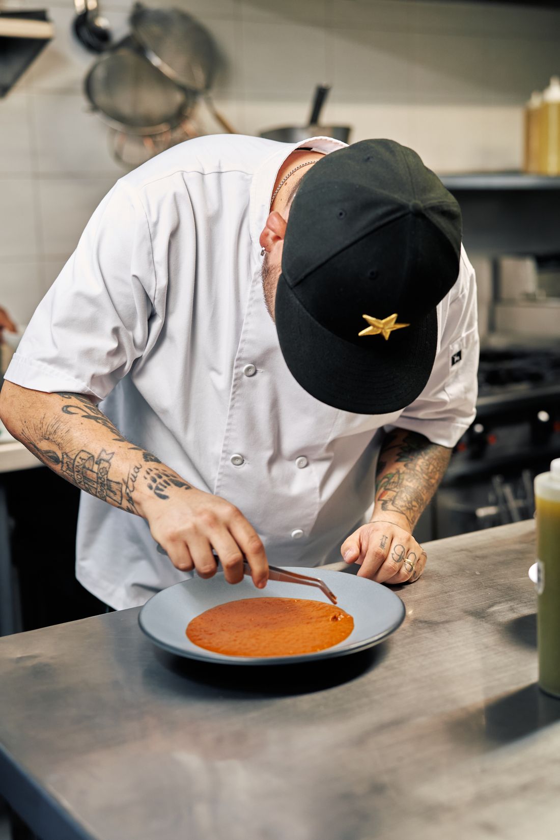 Chef finishing a gourmet dish in a professional restaurant kitchen