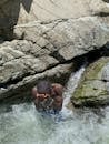 Young Man Enjoying a Refreshing Waterfall