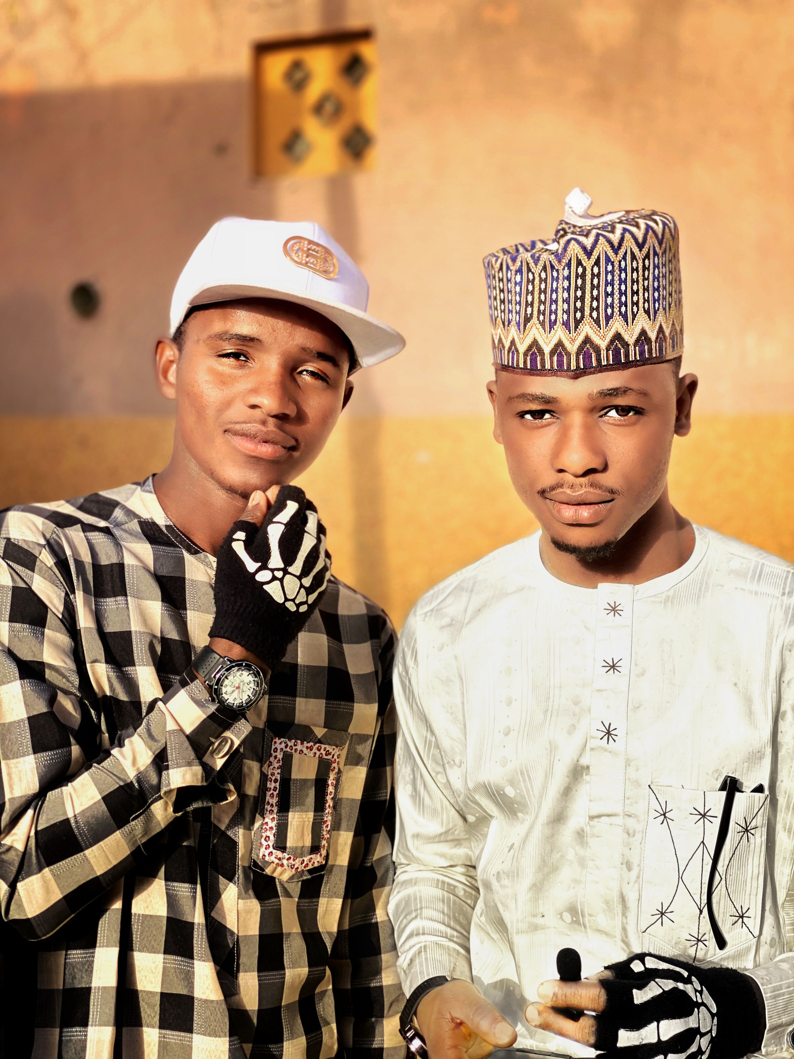 Two Young Men in Traditional and Modern Attire · Free Stock Photo