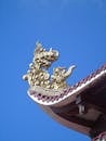 Ornate Dragon Roof Detail Against Clear Blue Sky