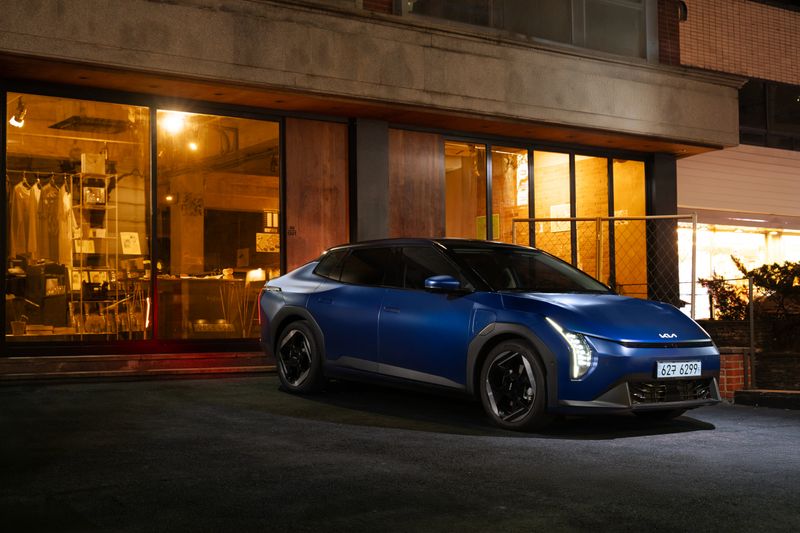 Electric vehicle parked on a city street at night