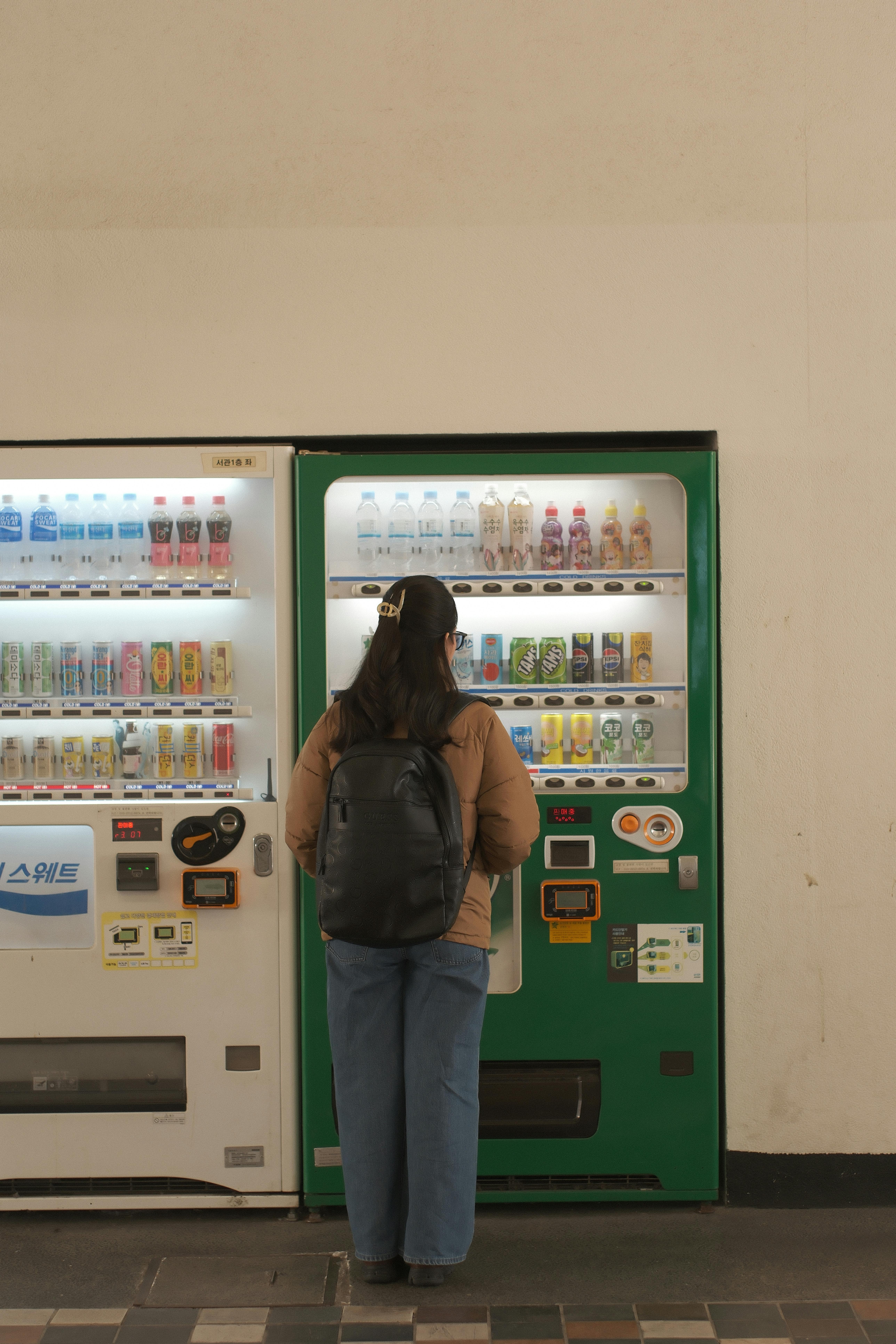 A woman standing at a vending machine