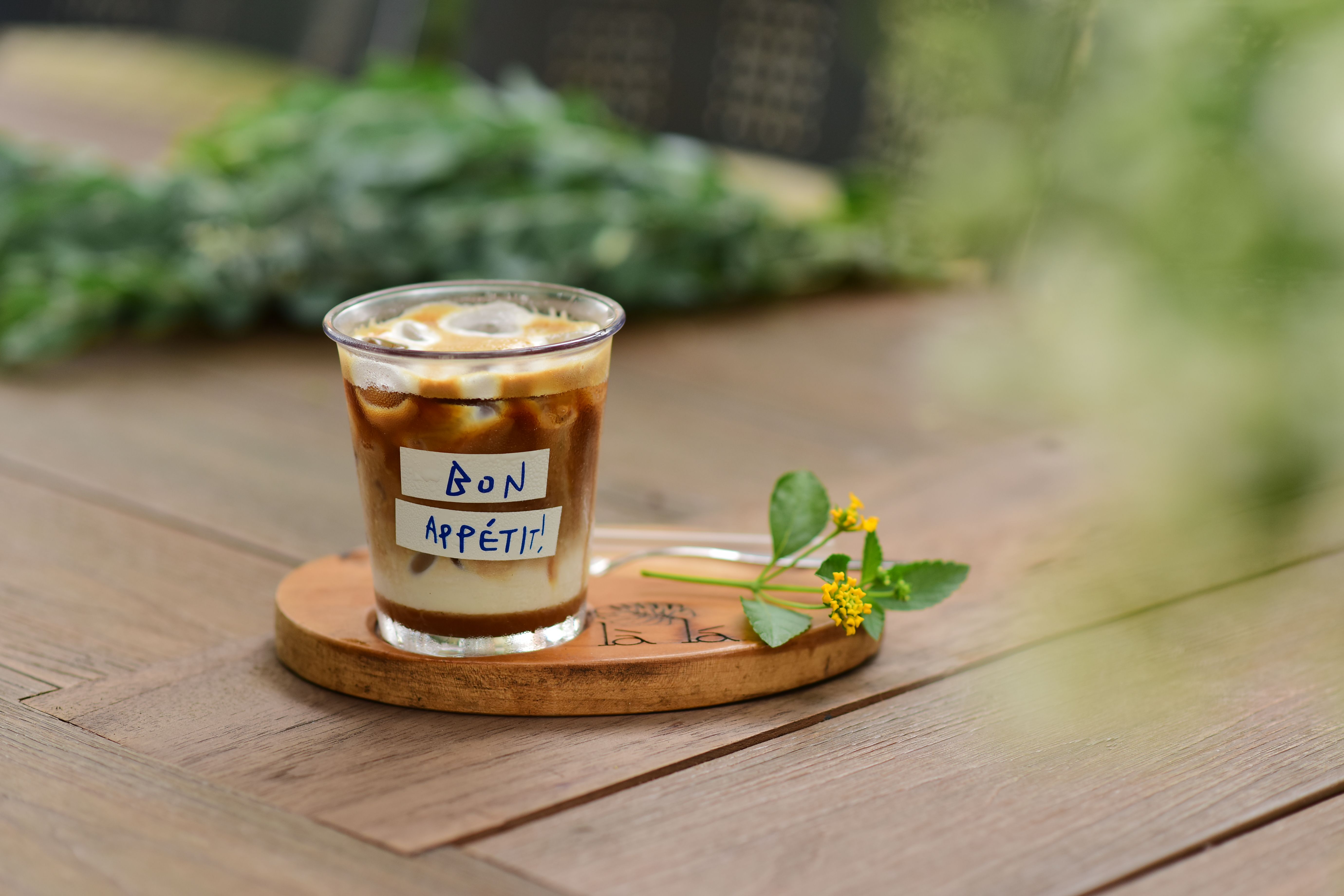 Iced Coffee with Bon Appétit Message on Wooden Table · Free Stock Photo