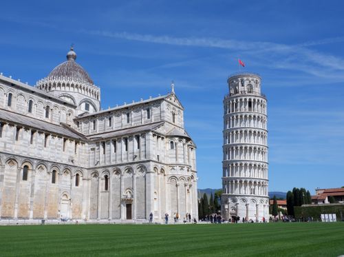 Free The iconic Leaning Tower of Pisa and Cathedral under a bright blue sky. Stock Photo