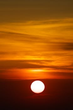 A breathtaking view of the sun setting in a golden sky, perfect for serene moments.