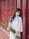Serene Woman in Traditional Ao Dai in Vietnam Temple
