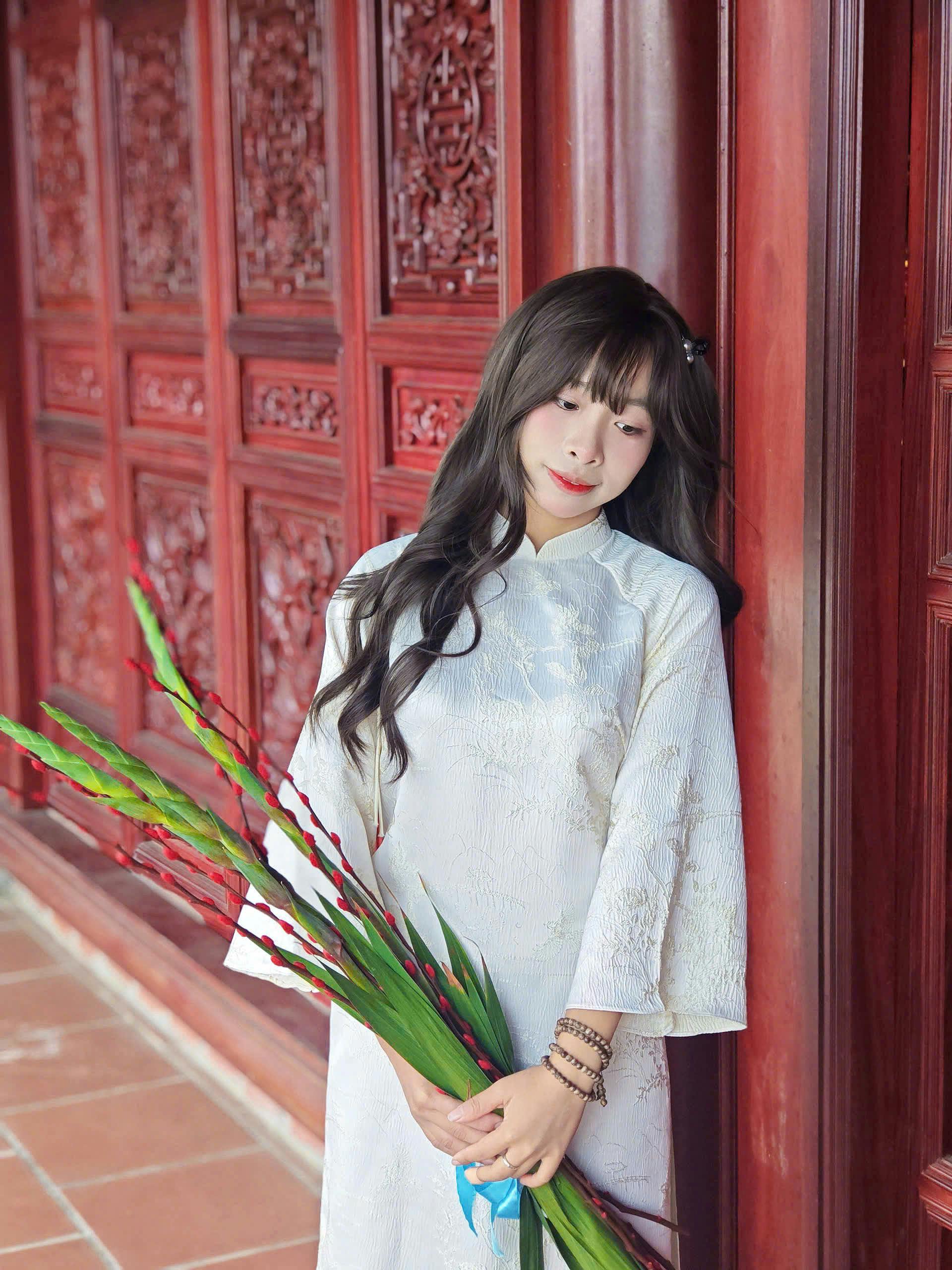 Serene Woman in Traditional Ao Dai in Vietnam Temple
