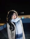 Young Woman in Winter Coat at Night in Vietnam