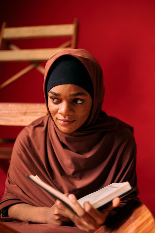 Young Woman Reading Book in Traditional Attire · Free Stock Photo