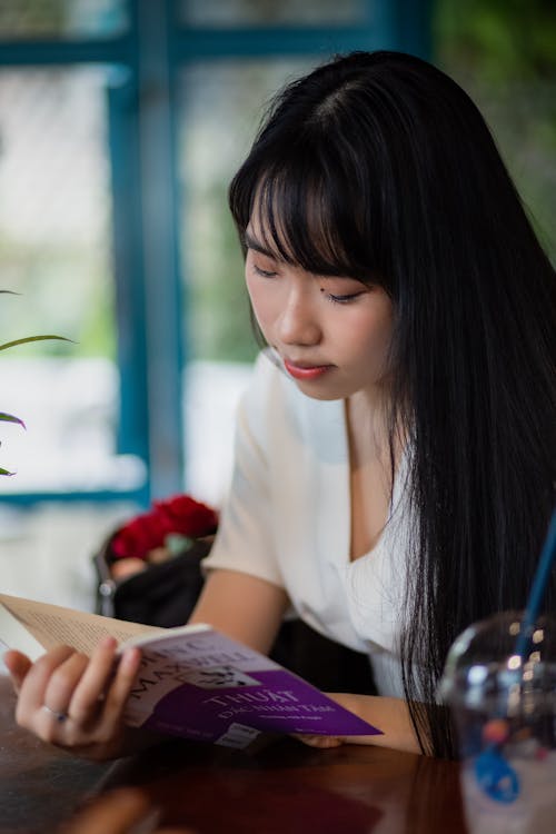 Free Woman in White Shirt Reading Book Stock Photo