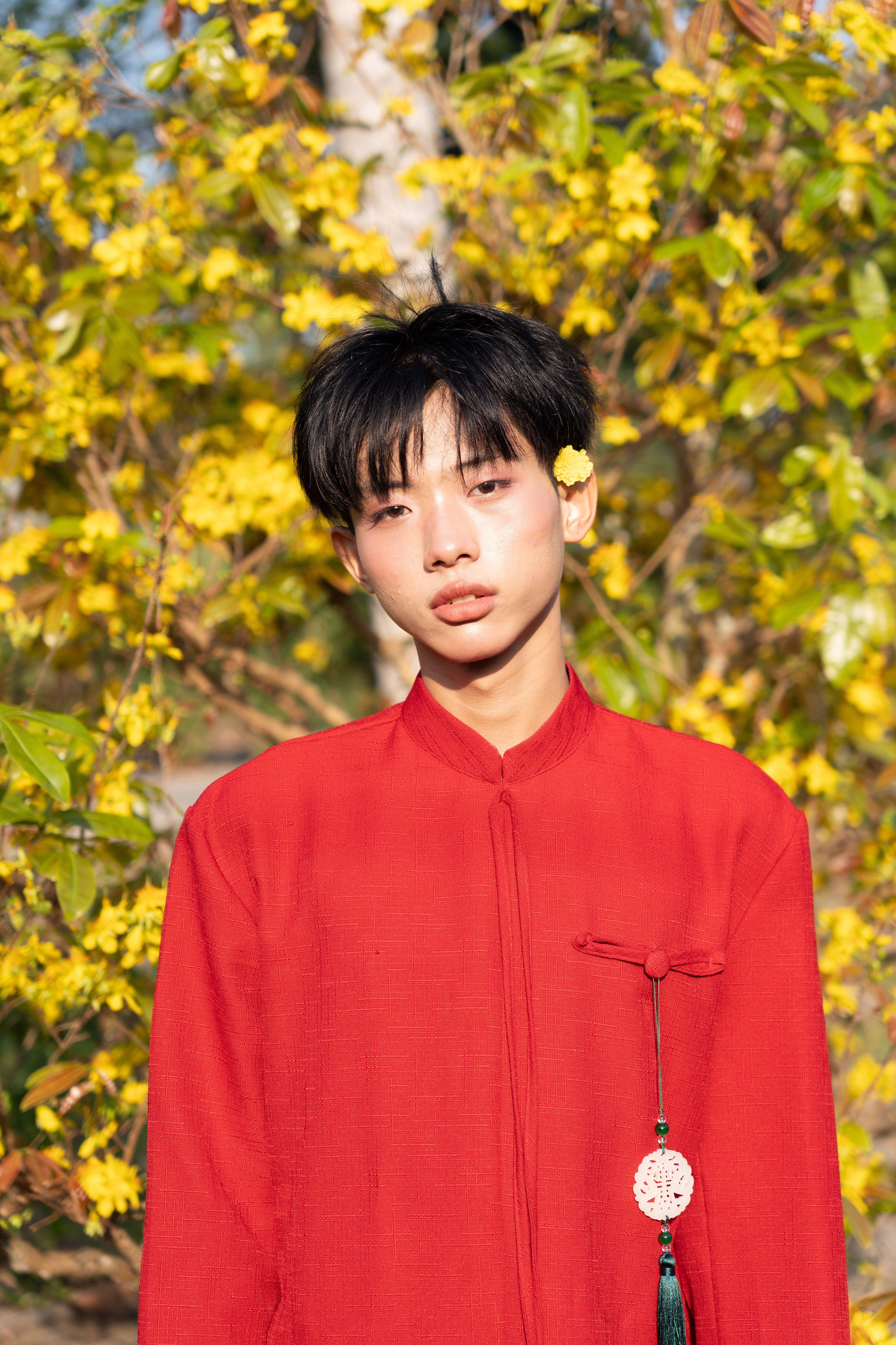 Young Man in Red with Yellow Blossoms · Free Stock Photo