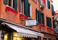 Charming Venetian Hotel Facade with Red Accents