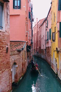 A picturesque scene of a gondolier on a Venice canal, surrounded by colorful buildings.