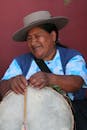 Smiling Woman Playing Traditional Drum