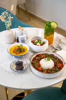 A beautifully arranged dining table featuring Middle Eastern cuisine with vibrant colors and artistic presentation.