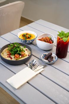 A vibrant Middle Eastern meal with appetizers and fresh mint tea served on a stylish table.