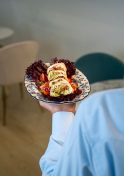 Elegant vegetarian wraps served with fresh lettuce and tomato on a stylish platter.