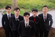 Group of Young Men in Formal Suits Outdoors