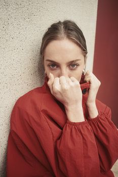 Portrait of a woman wearing a red coat against textured wall, İstanbul