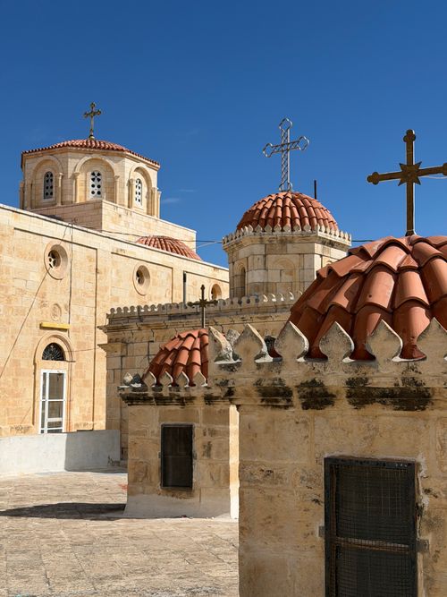 Free View of historic Jerusalem church domes with crosses under a vibrant blue sky. Stock Photo