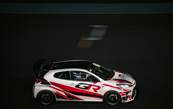 Dynamic high-speed racing car captured with motion blur in Kuwait City.