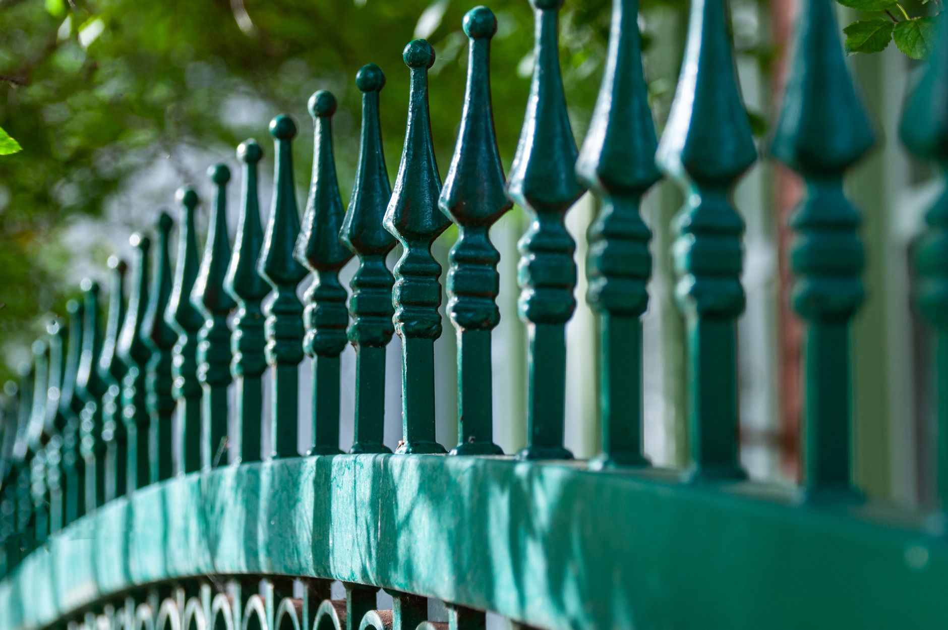 Decorative metal fence with intricate design detail showing long-term craftsmanship and durability