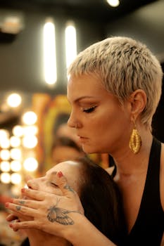 Makeup artist skillfully applies makeup to a client in a studio setting, showcasing expertise and creativity.