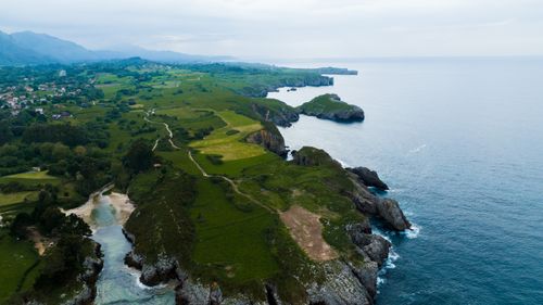 Free Aerial view of lush coastal cliffs and the sea in Northern Spain. Stock Photo
