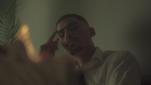 A man indoors under moody, cinematic light — photo by Houssam benamara on Pexels
