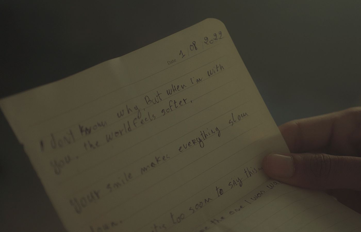 A heartfelt handwritten note expressing love and emotions in soft lighting.
