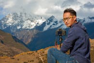 Photographer Capturing Scenic Mountain View in Sichuan