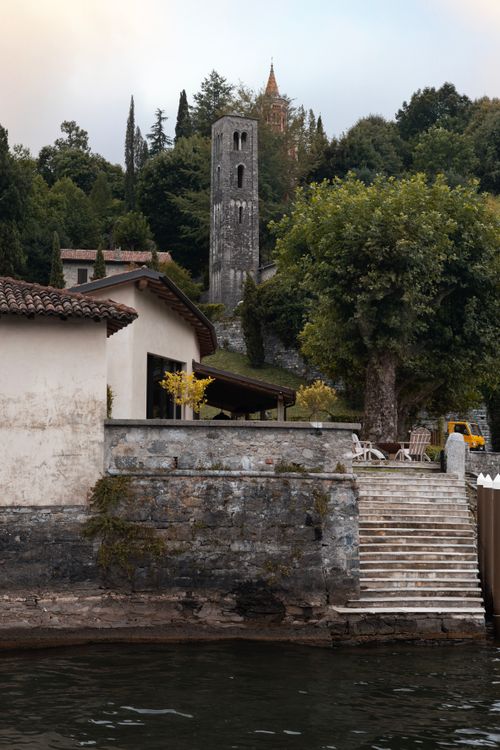 Free Charming view of a historic tower and lakeside architecture in Como, Lombardy, Italy. Stock Photo